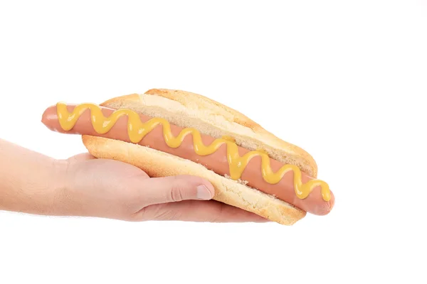 Hotdog met mosterd in hand — Stockfoto