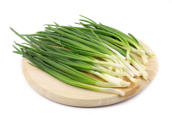 Green onion on wooden platter — Stock Photo, Image