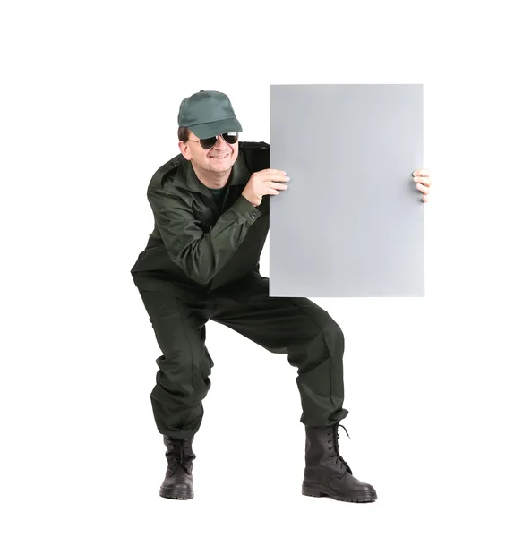 Man in workwear holds paper sheet — Stock Photo, Image