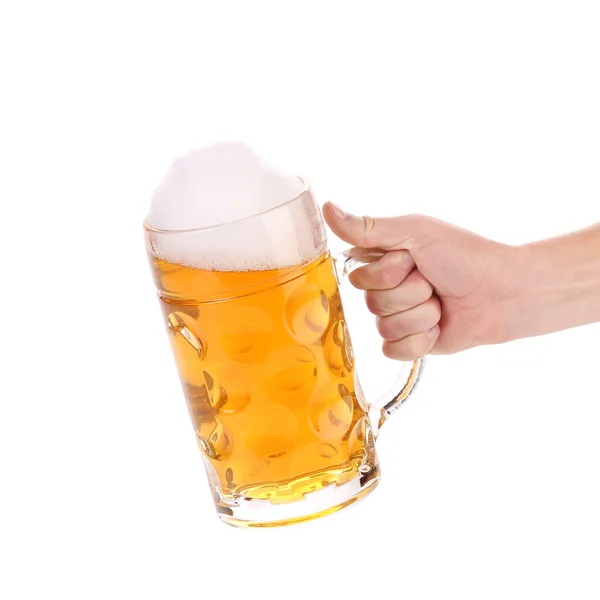 Mug of beer with froth in hand — Stock Photo, Image