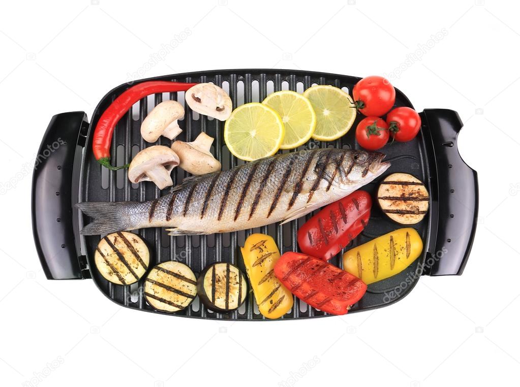 Seabass on grill with vegetables