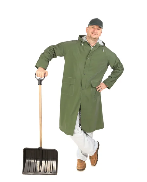 Man in long vest with shovel — Stock Photo, Image