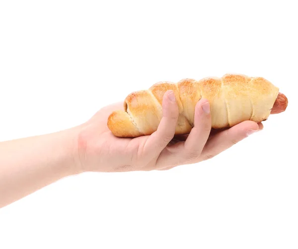 Hand holds a Baked hot dog — Stock Photo, Image