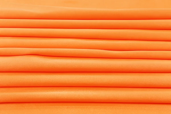 Folded orange silk. — Stock Photo, Image