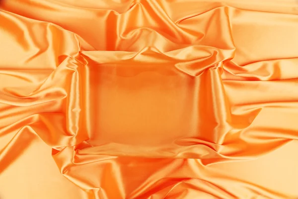 Vierkant in oranje stof. — Stockfoto
