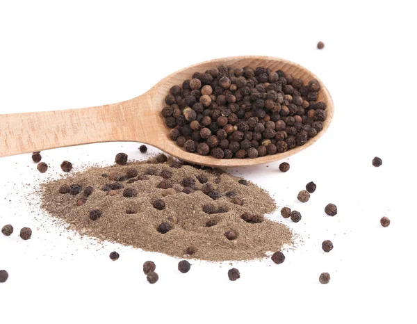 Black peppercorns and milled in wooden spoon — Stock Photo, Image