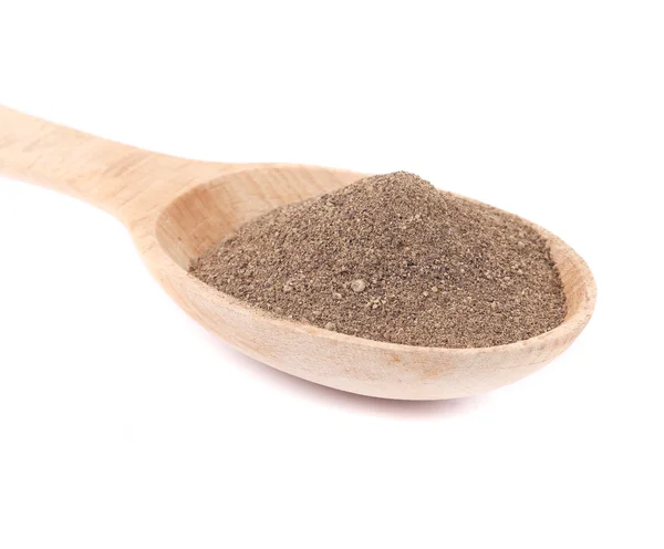 Milled black pepper in wooden spoon — Stock Photo, Image