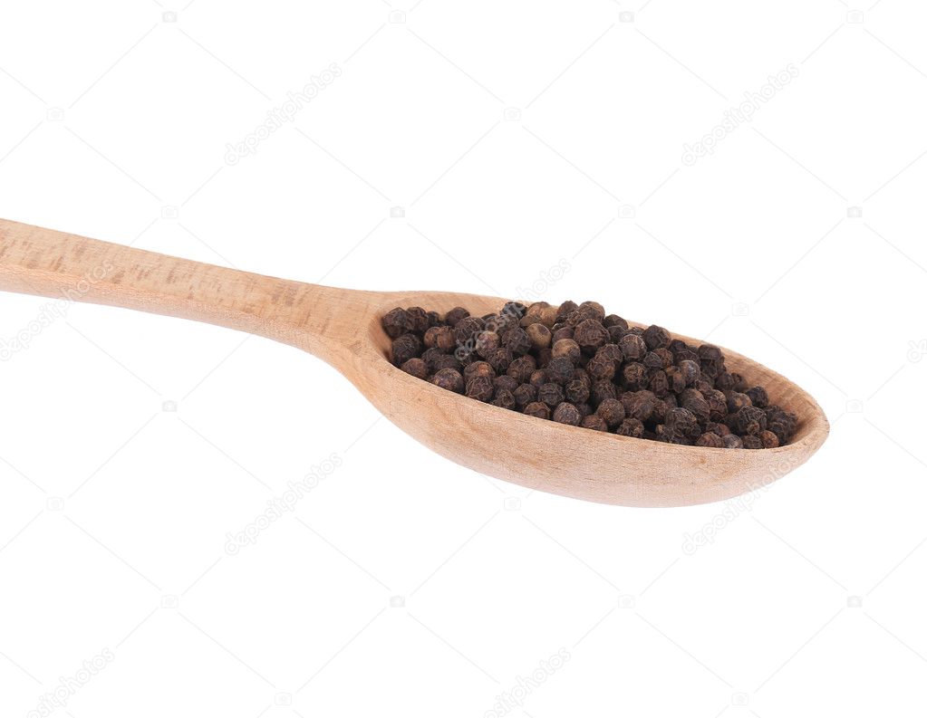Black peppercorns on a wooden scoop