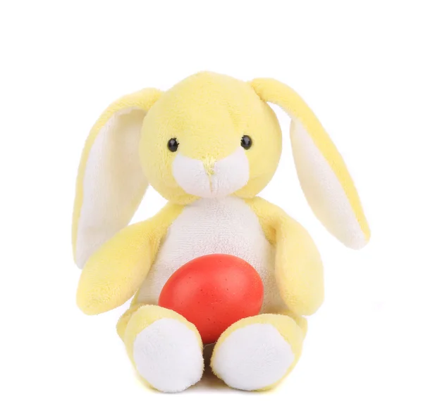 Yellow toy rabbit with easter egg. — Stock Photo, Image