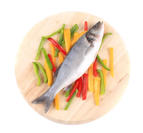 Fresh seabass fish on colorful pepper. — Stock Photo, Image