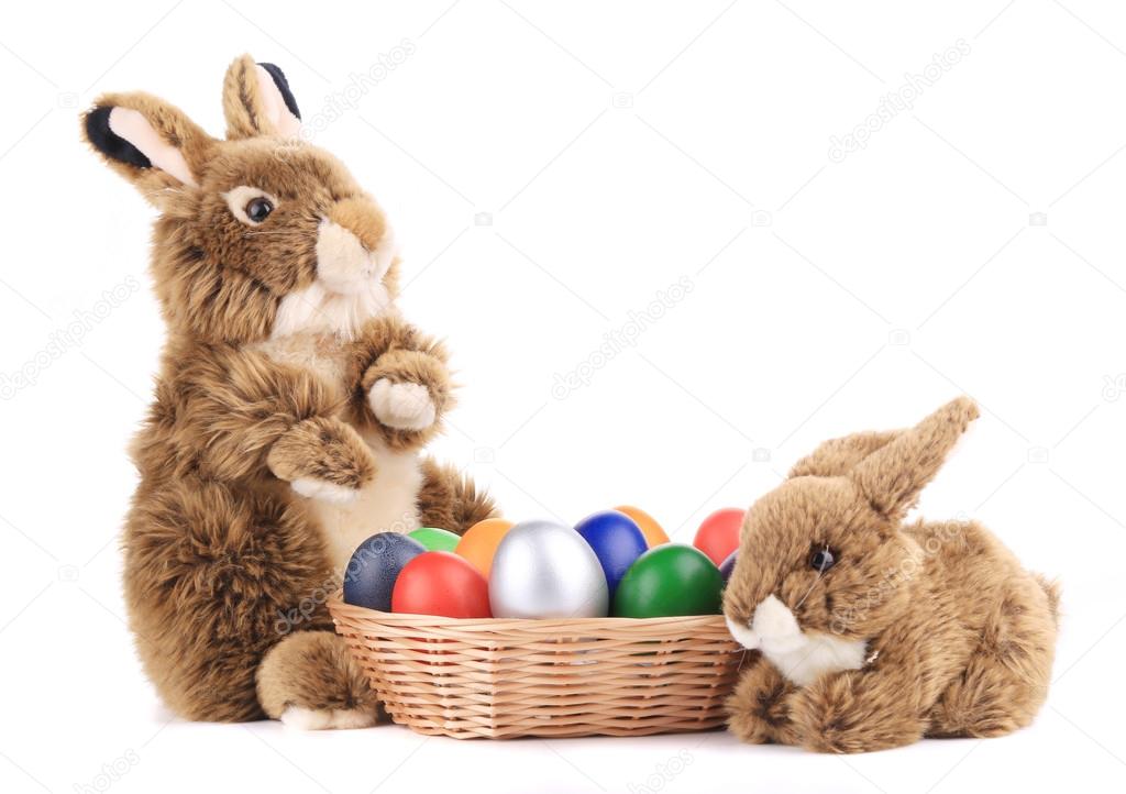 fluffy foxy rabbit in basket with easter eggs.