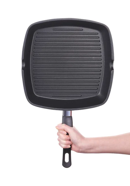 Hand holds a black frying grill pan — Stock Photo, Image