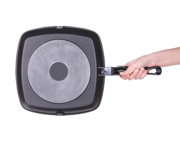 Hand holds a black frying pan — Stock Photo, Image