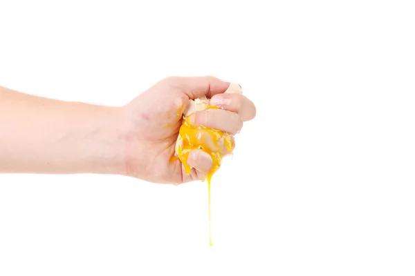 Hand smash egg yolk — Stock Photo, Image