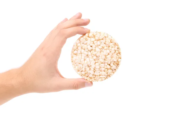Hand holds puffed wheat bread. — Stock Photo, Image