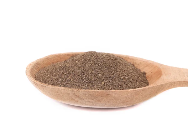 Wooden spoon with powdered black pepper. — Stock Photo, Image