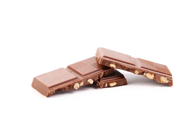 Broken chocolate stack with hazelnuts. — Stock Photo, Image