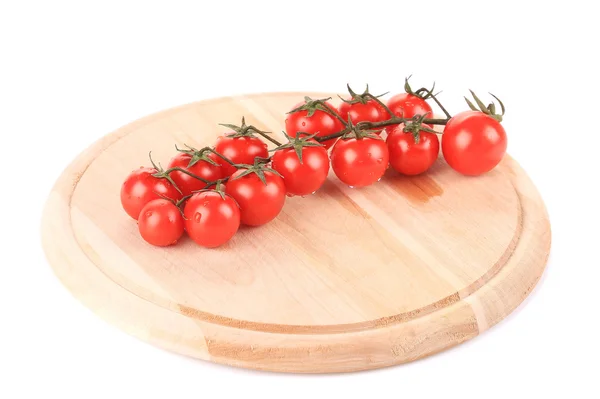 Cluster of Tomatoes on wooden platter. — Stock Photo, Image