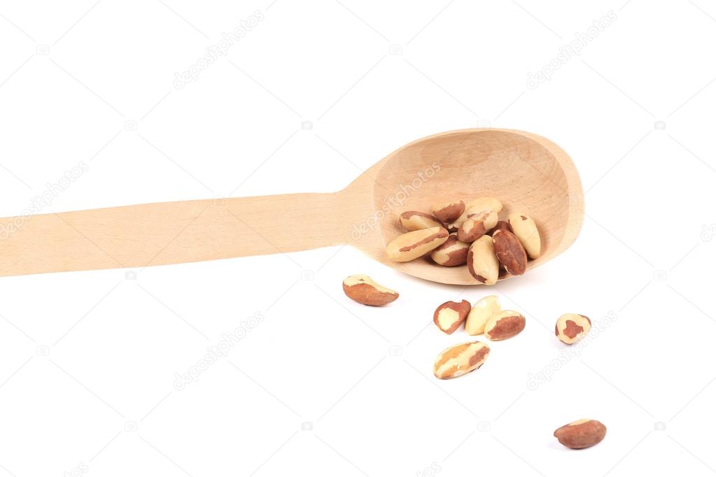 Brazil nuts in wooden spoon.