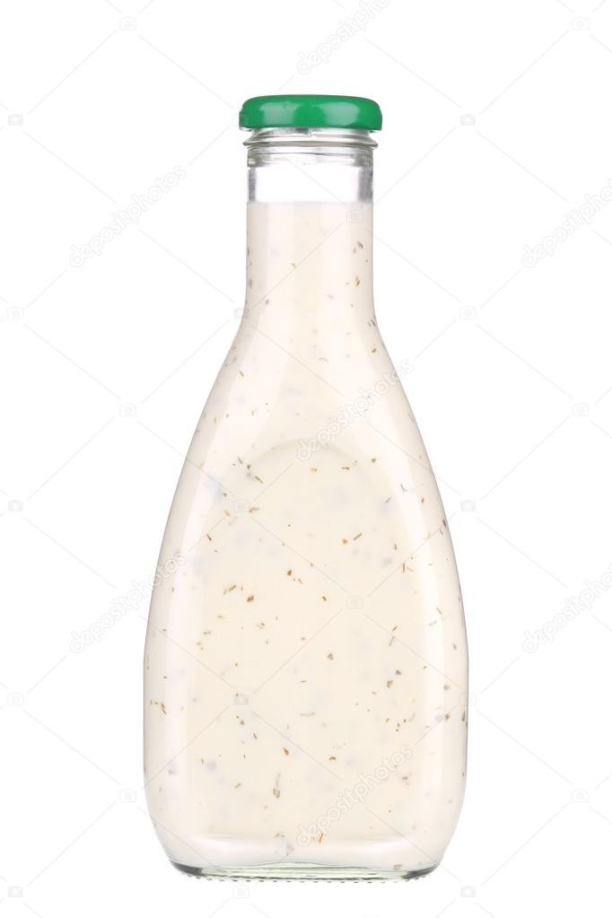 Glass bottle of white sauce.