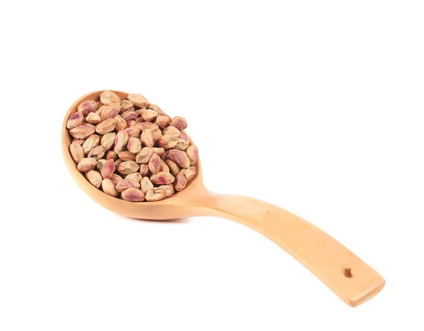 Wooden spoon with peeled pistachios. — Stock Photo, Image