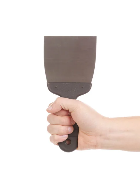 Hand holds metal spatula. — Stock Photo, Image