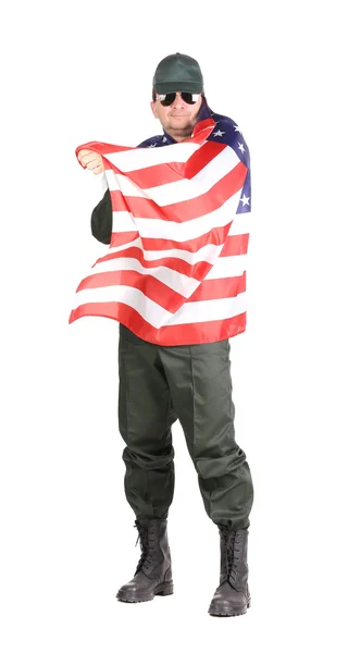 Man in workwear stands with american flag. — Stock Photo, Image