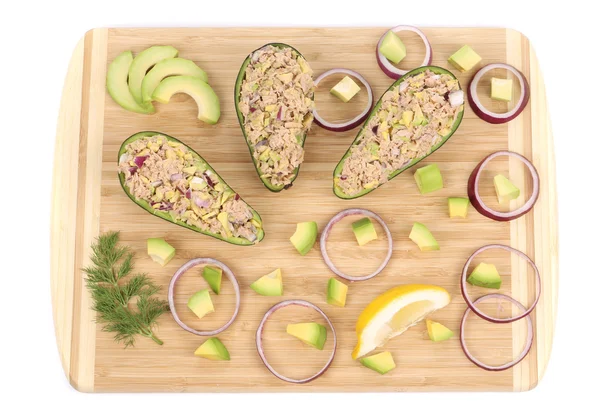 Avocado salad with tuna on cutting board. — Stock Photo, Image