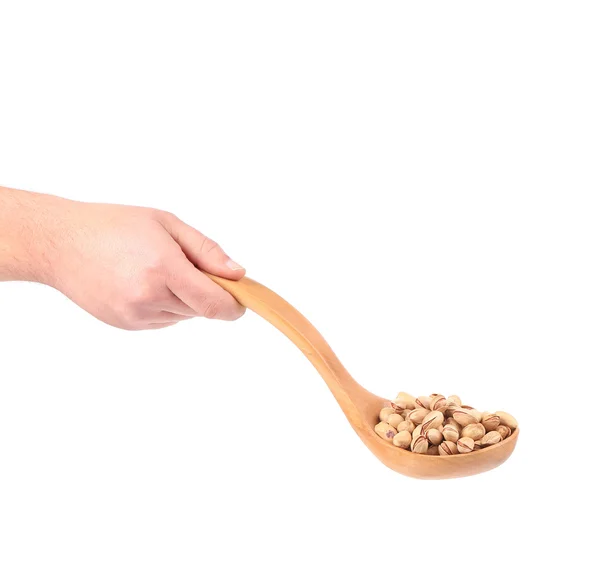 Hand holding spoon with pistachios. — Stock Photo, Image
