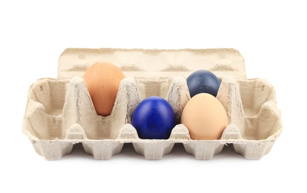 Cardboard egg box with colored easter eggs. — Stock Photo, Image