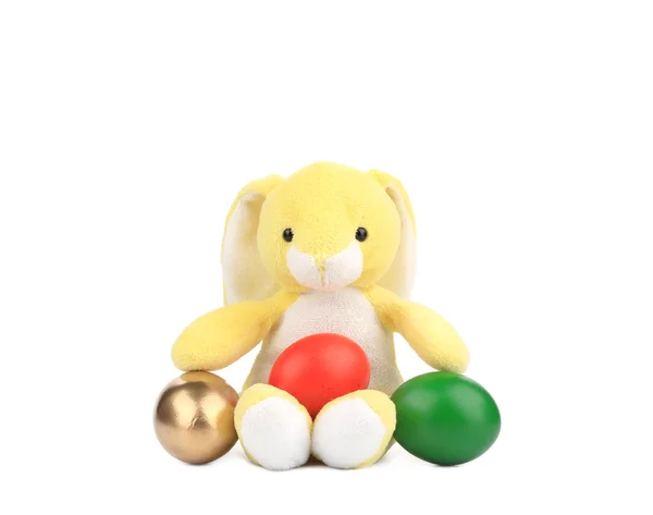 Yellow toy rabbit with easter eggs. — Stock Photo, Image