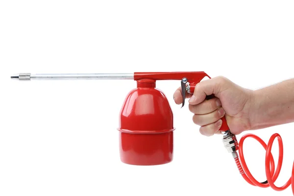 Hand holds spray gun with plastic spring. — Stock Photo, Image
