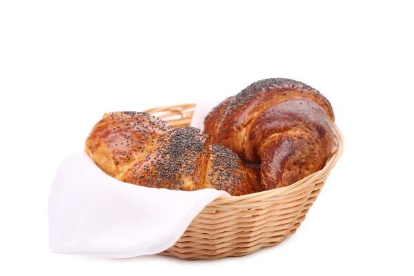 Tasty croissants with poppy on wicker basket. — Stock Photo, Image