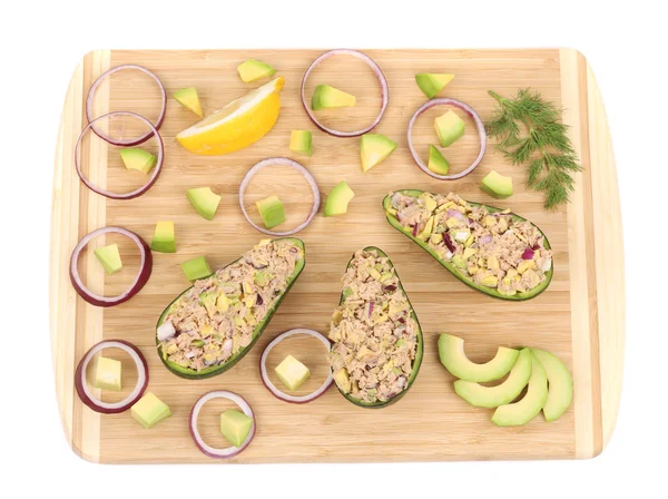 Avocado salad with tuna on cutting board. — Stock Photo, Image