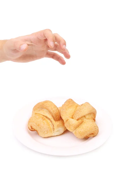 Hand nimmt Croissant. — Stockfoto