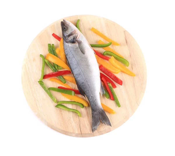 Fresh seabass fish on colorful pepper. — Stock Photo, Image