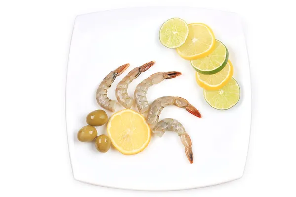 Raw shrimp with lemon and olive. — Stock Photo, Image