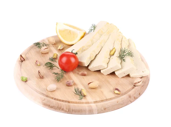 Slices of tofu on wooden platter. Royalty Free Stock Photos