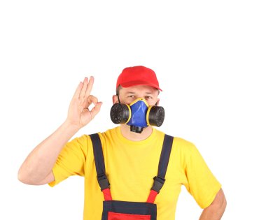 Worker in gas mask showing okay sign.