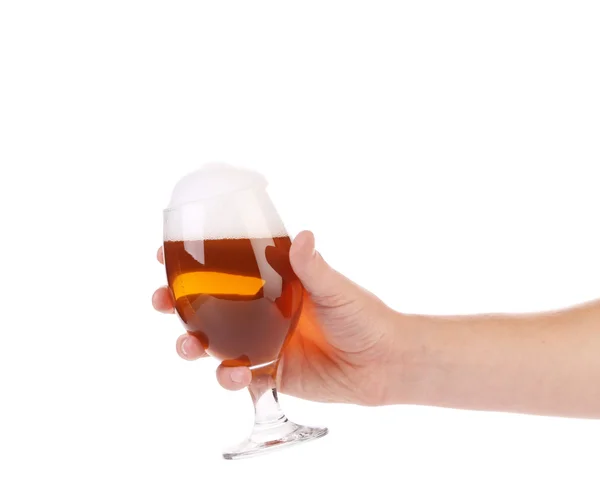 Glass of beer with foam in hand. — Stock Photo, Image