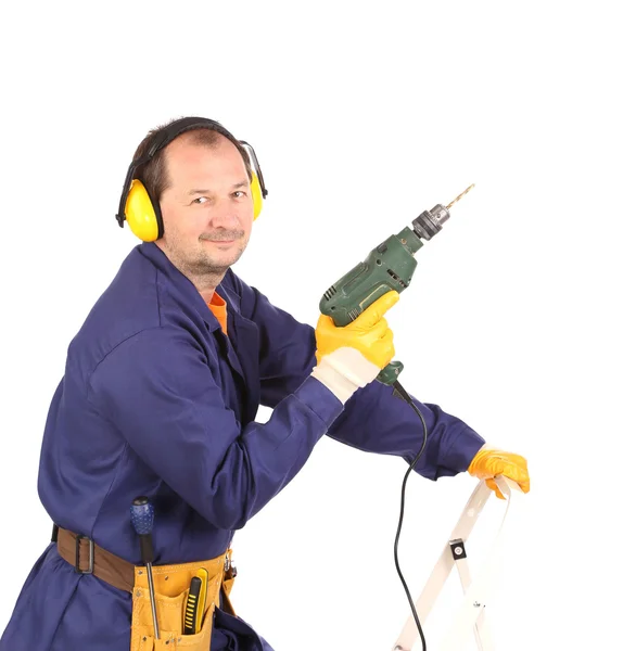 Trabajador de pie con taladro verde . — Foto de Stock