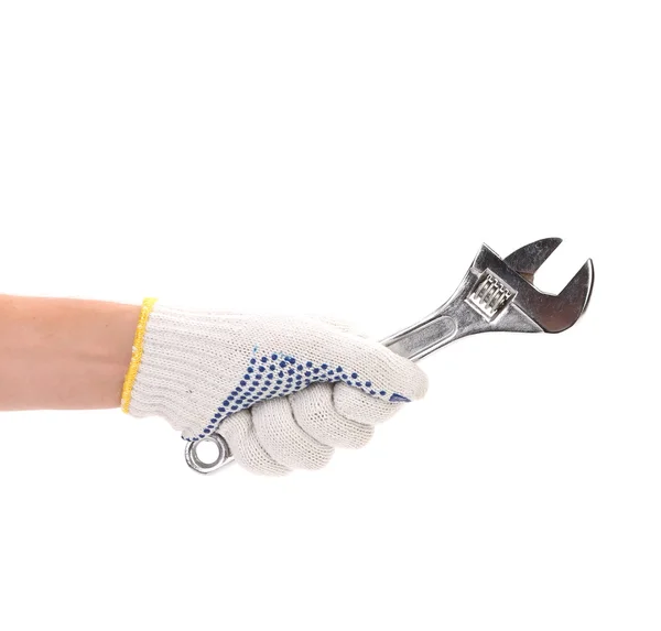 Hand in gloves holding adjustable wrench. — Stock Photo, Image
