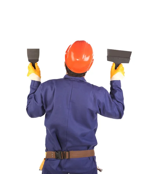 Pracovník v čepice drží špachtle. — Stock fotografie