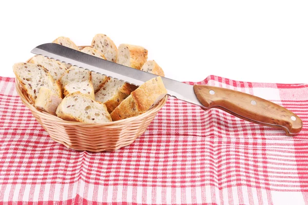 Basket with sliced bread and knife. — Stock Photo, Image