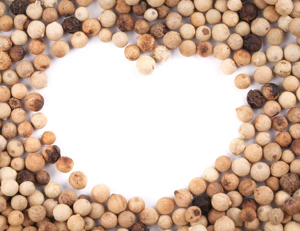 White peppercorn in shape of heart. — Stock Photo, Image