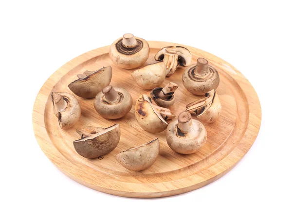 Mushrooms on wooden platter. — Stock Photo, Image