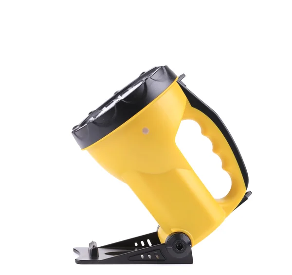 Gelbe Taschenlampe mit Griff aus Kunststoff. — Stockfoto