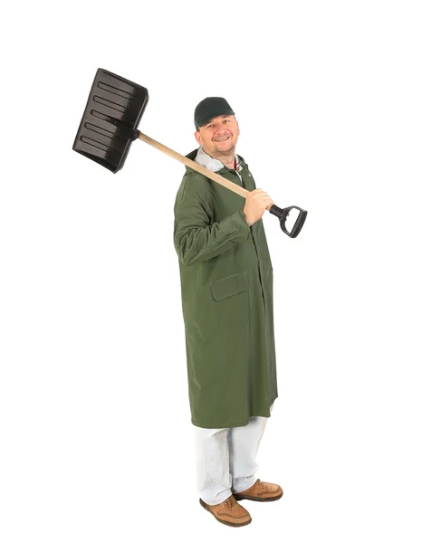 Man in long vest with shovel. — Stock Photo, Image