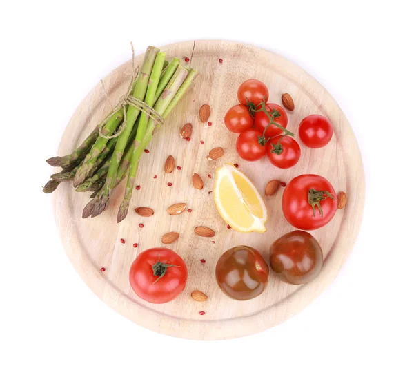 Asparagus and tomatoes on wooden board. — Stock Photo, Image