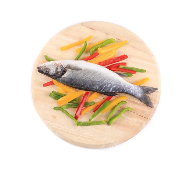 Fresh seabass fish on colorful pepper. — Stock Photo, Image